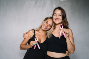 Women holding pink ribbons.