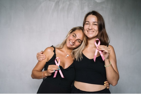 Women holding pink ribbons