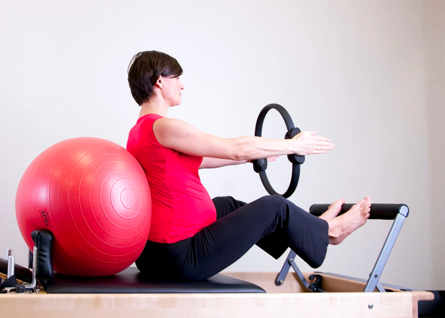 A woman uses exercise equipment while working out.